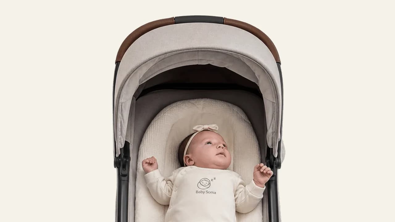 A drowsy baby showing early sleepy cues while lying calmly