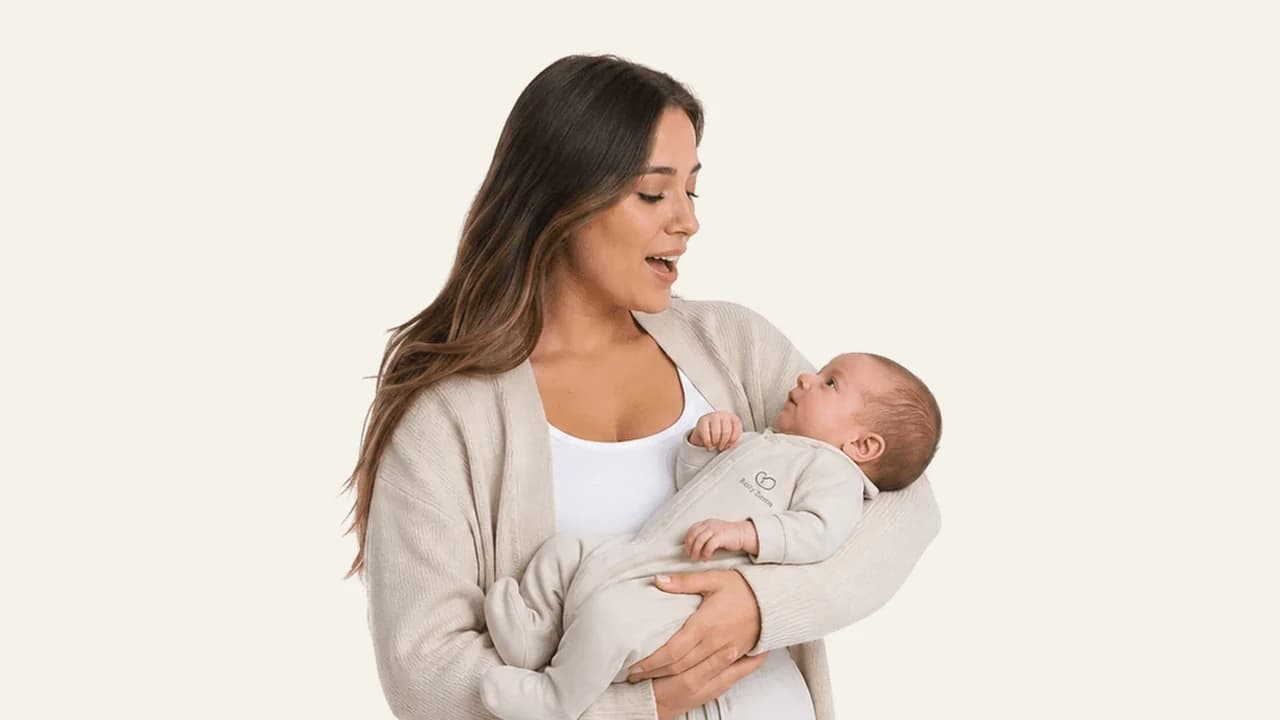 A parent gently soothing a drowsy baby toward sleep