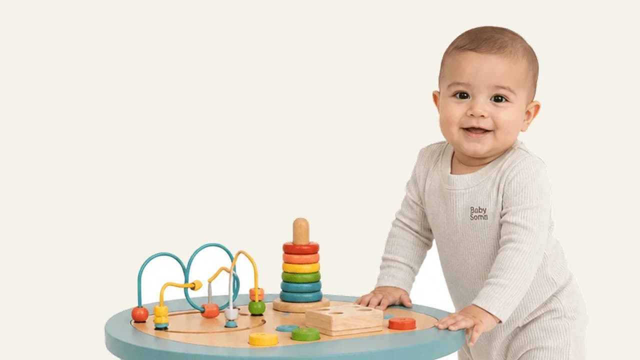 A one year old baby standing with support during an awake window