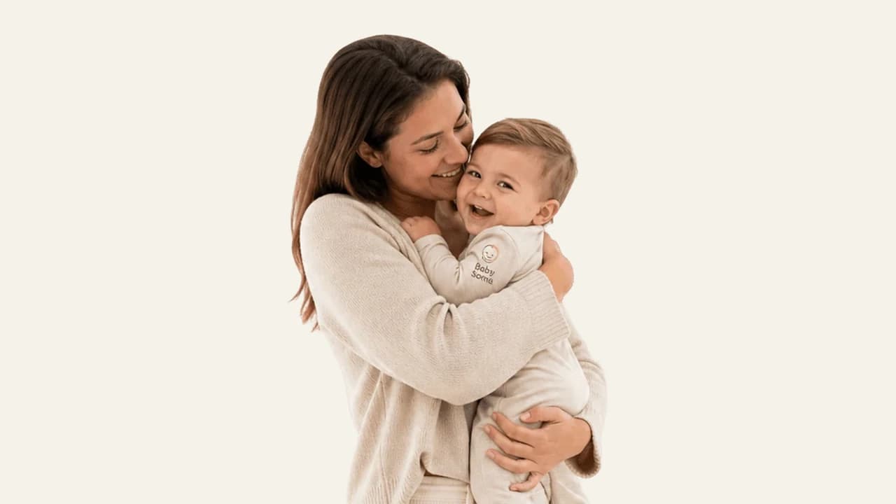 A parent comforting a baby with a hug just before bedtime