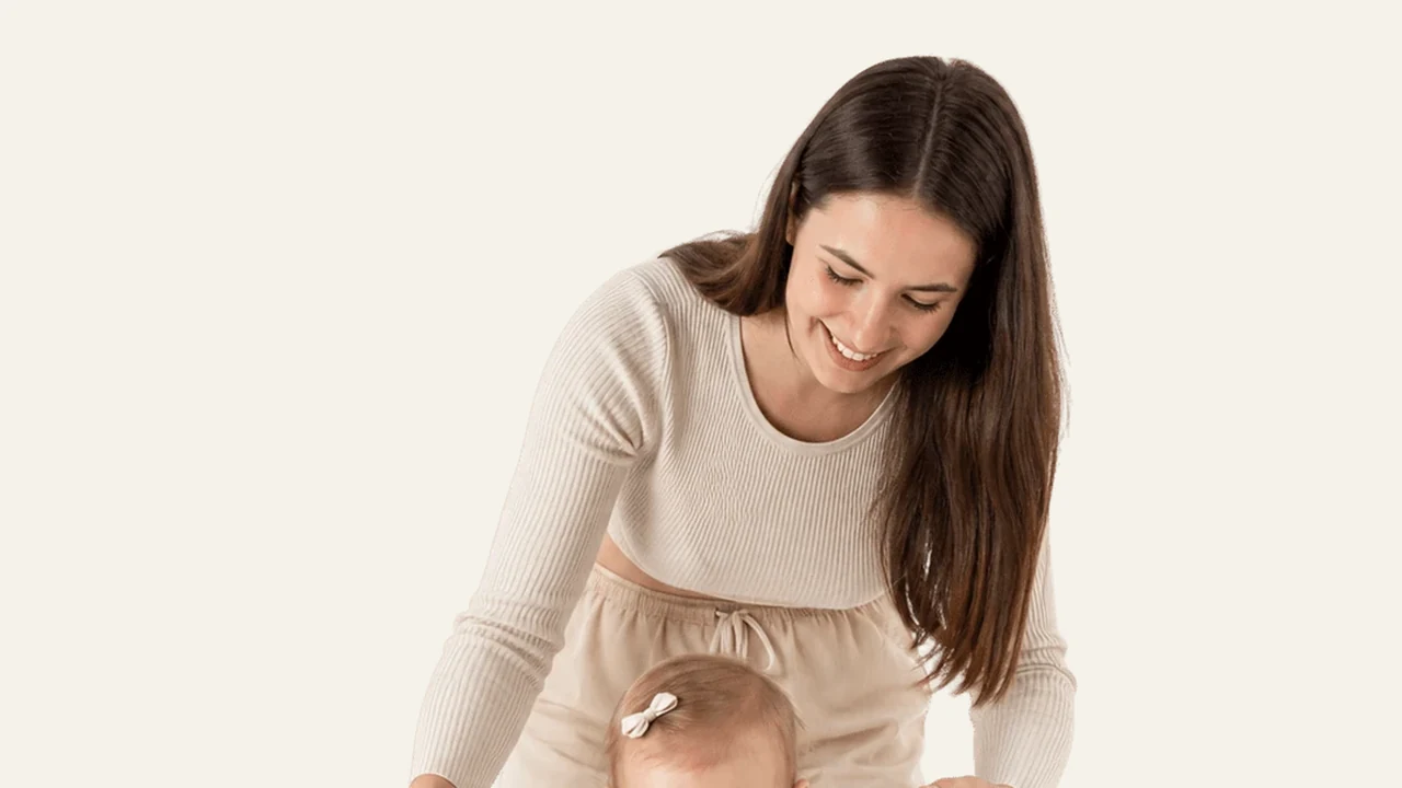 An older baby taking supported steps while dropping a nap