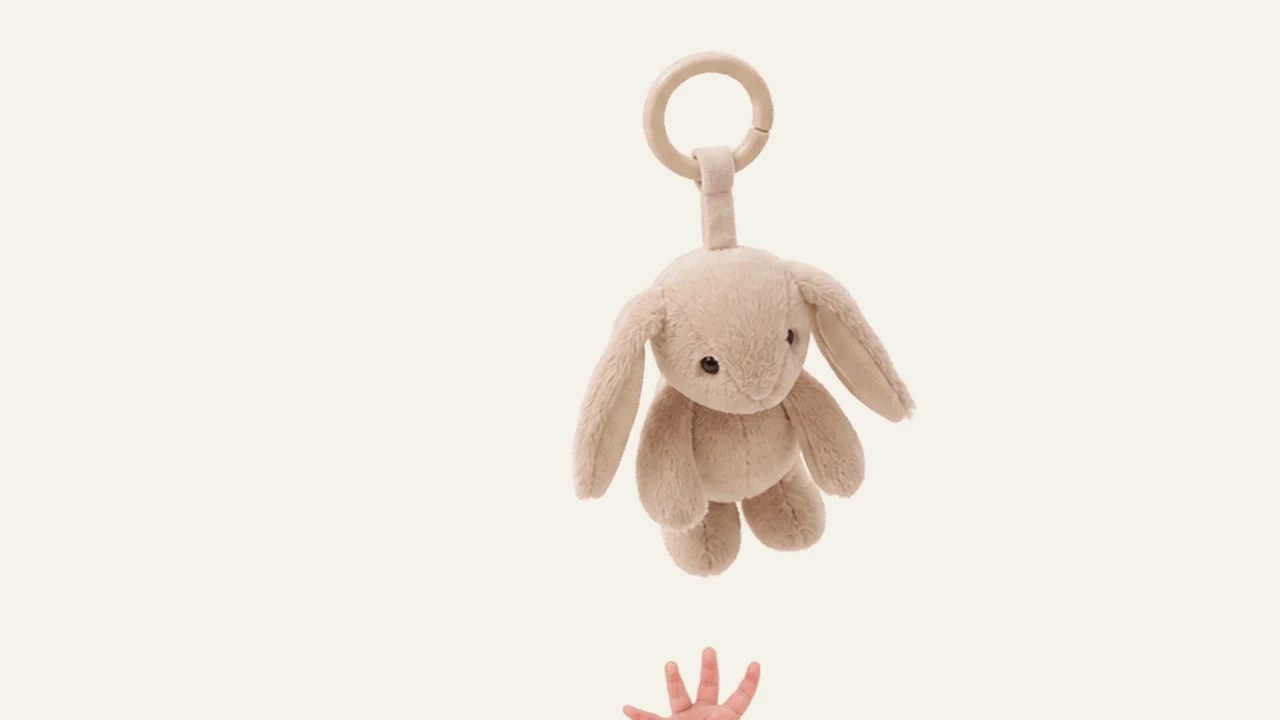 A six month old baby happily reaching for a toy during an awake window